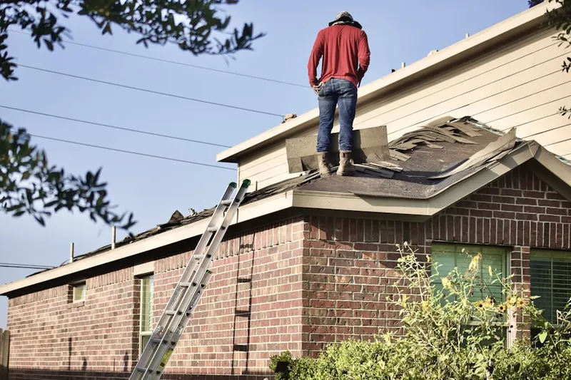 Professional roofer working on a residential roof in Falcon Trace
